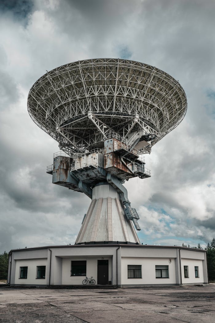 Capture of a large radio telescope set against a moody sky, ideal for space and technology themes.