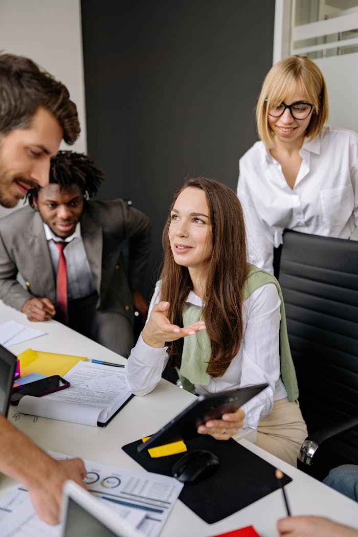 A multi-ethnic team brainstorming and collaborating in a modern office setting.